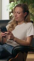 Pondering business woman using mobile phone thinking typing answer mobile phone at home Caucasian pensive female businesswoman freelancer sitting indoor browsing smartphone texting chat idea solution video