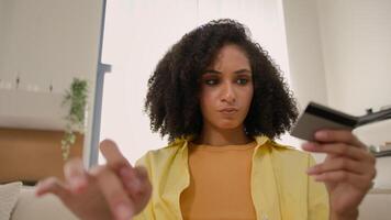 POV webcam view African American woman upset stressed girl pay online with laptop and credit card failure error secure number no money problem reject bank payment bankruptcy blocked account at home video