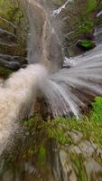 Epic FPV drone dive into powerful multi-stream Tumpak Sewu waterfall, deep green canyon, and lush rainforest in East Java, Indonesia. video