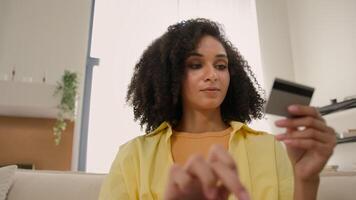 POV point of view shot from computer webcam African American ethnic woman happy girl businesswoman pay online service shopping enter code number of credit card easy bank transaction payment on laptop video