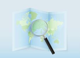 Magnifying glass on a world map vector
