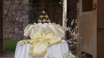 Elegant dessert table displayed at a luxurious wedding reception. Action video
