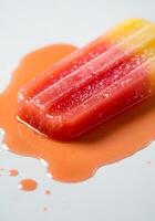 Melting Strawberry Lemonade Popsicle on White Surface photo