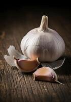 Garlic Bulb and Cloves on a Rustic Wooden Table photo