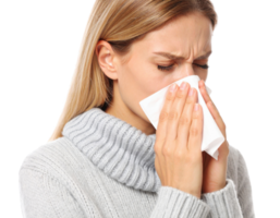 Young woman blowing nose into tissue while suffering from cold, flu or allergies png