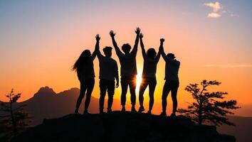 Silhouetted Group of Youngs Celebrating Victory on Mountain Peak at Golden Sunset Symbol of Unity Ambition and Triumph photo