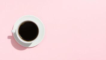 A top down view of a white cup of black coffee with rich crema placed photo