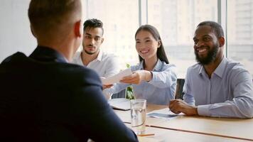 In a contemporary office, a diverse team discusses strategies and shares ideas. They are focused and engaged, promoting teamwork and innovative solutions to achieve business success. video