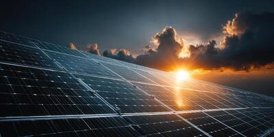 Dramatic sunset illuminates a field of solar panels, showcasing clean energy. photo