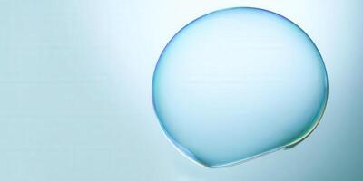A large soap bubble floats with stunning iridescence against a soft blue backdrop. photo