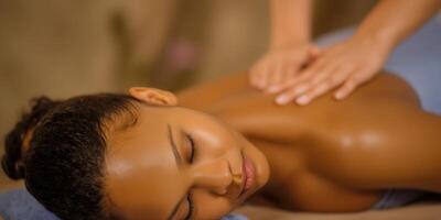 A woman enjoying a back massage at a spa, promoting relaxation and wellness. photo