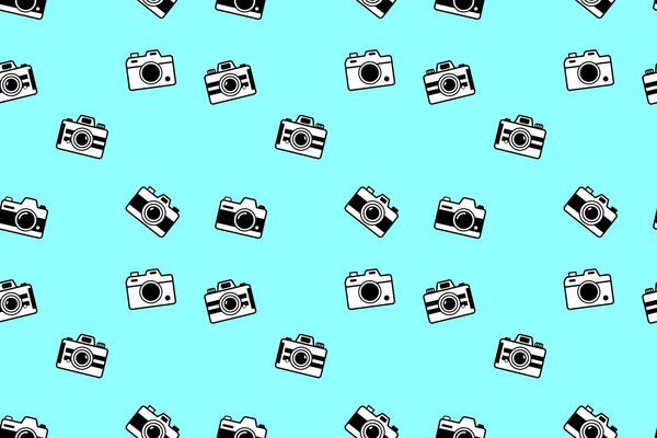 Playful pattern of retro black cameras on vibrant turquoise, perfect for photo themed merchandise, fun branding, creative packaging, or scrapbook assets
