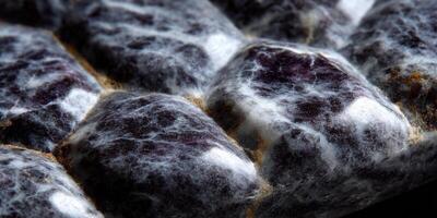 An abstract texture shows a close-up of a detailed, layered surface in shades of purple and white. photo