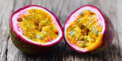 Two halves of a passion fruit, showcasing the vibrant yellow pulp and seeds. photo