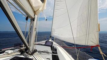 Sailing yacht moving at full speed with all sails up in the open sea near Croatia. Dynamic maritime adventure and freedom of ocean travel. High quality 4k footage video