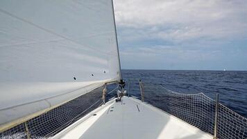 Bow of a sailing yacht cutting through the sea with sails fully open near Croatia. Freedom, motion, clean energy and slow travel on the open water. High quality 4k footage video