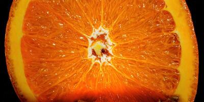 A vibrant close-up of a juicy orange slice, perfect for healthy eating and freshness. photo