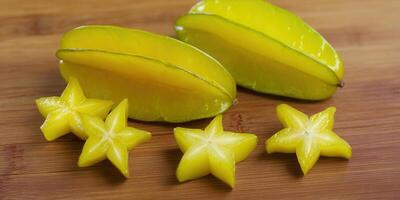 Vibrant close-up of star fruits, showcasing the beauty of whole and sliced carambolas. photo