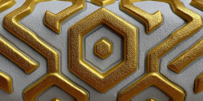Intricate gold geometric pattern on a textured, neutral colored surface. photo