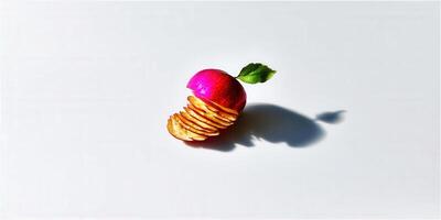 A creative still life featuring a red apple with potato chips on a white surface under bright lighting. photo