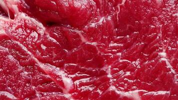 Raw beef texture stop motion background with fresh, marbled red meat. Juicy steak surface conveys freshness, quality, and flavor. Ideal for food and culinary projects. video