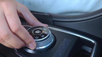 Close-up of hand turning gear shift knob in modern car interior. Driver switches transmission in drive mode on automatic gearbox video