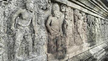 Ancient Bas-Relief Carvings Depicting Figures on Stone Temple photo