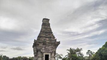 Ancient Stone Temple Against Cloudy Sky Architectural Detail and Serenity. photo