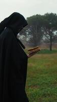 Anonymous Man With Mysterious Cloak Walks Reading Grotesque Book video