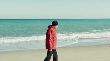 Elderly Man in a Jacket Walks Calmly by the Sea video