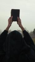 Anonymous Religious Man Raises Holy Bible To The Sky On A Dull Day video