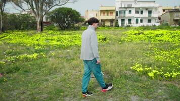 Man Walking In The Nature And Picking A Yellow Flower From The Grass video