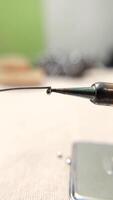 Vertical Shot of Heating the Soldering Iron. A detailed view of a soldering. video