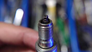 Close-Up View of a Hand Holding a Used Spark Plug video
