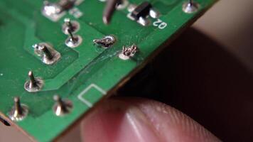 Soldering electronic components onto a circuit board during a precision electronics assembly process. video