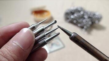 Detailed view of soldering tools used for electronics and maintenance. The image showcases precision soldering tips and equipment, ideal for professional or hobbyist use. video