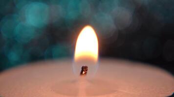Close-Up of a Candle Flame Against a Soft Blue Bokeh Background. Macro shot of fire on candle video