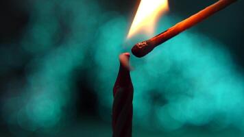 Igniting a Candle with a wooden matchstick on Soft Blue Bokeh Background. Close-up of candle wick detail video