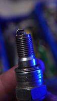 Close-up of automotive spark plugs displaying visible signs of wear and usage, highlighting their condition after extended engine performance. video
