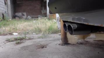 A car exhaust pipe releasing smoke, symbolizing air pollution and vehicle emissions. video