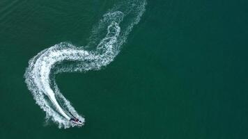Jet ski gliding across the water with splashes, captured from above. Concept speed, summer fun, vacation and water adventure. video
