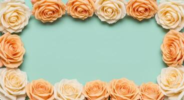 Frame of Peach and Cream Roses on Mint Green Background, Floral Border, Copy Space, Flat Lay photo