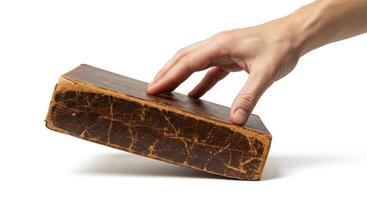 Hand Touching Old Leather-Bound Book, Isolated on White Background, Close-Up, Study Concept photo