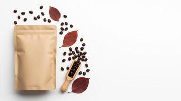 Coffee Beans, Autumn Leaves, and Kraft Bag on White Background, Top View photo