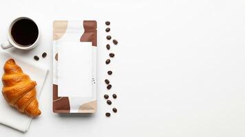 Coffee Cup, Croissant, and Coffee Beans with Blank Coffee Bag on White Background photo
