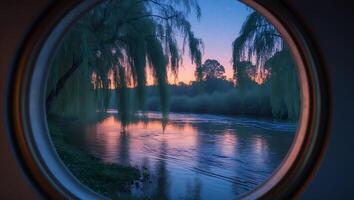 River View Through Round Window with Weeping Willows and Sunset photo