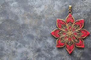 Intricate Red and Gold Floral Pendant on Textured Gray Background. A decorative design element perfect for invitations, websites, or branding projects. photo