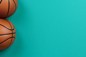 Two Basketballs on a Teal Background Perfect for Sports-Themed Designs and Presentations. photo