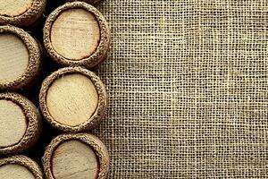 Wooden Discs with Burlap Texture Background for Craft, Wine, or Rustic Designs. photo