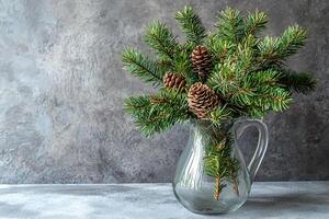Festive Fir Branches and Pinecones in a Glass Pitcher. A Rustic Winter Arrangement. photo